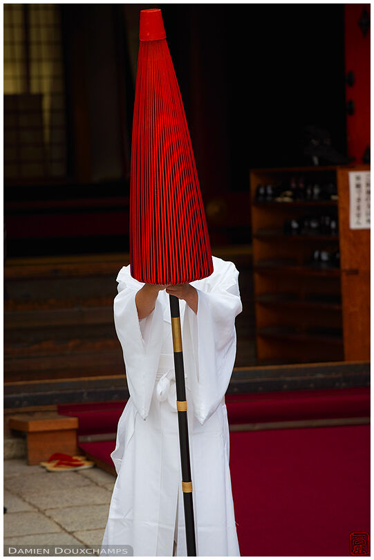 White robe, red umbrella