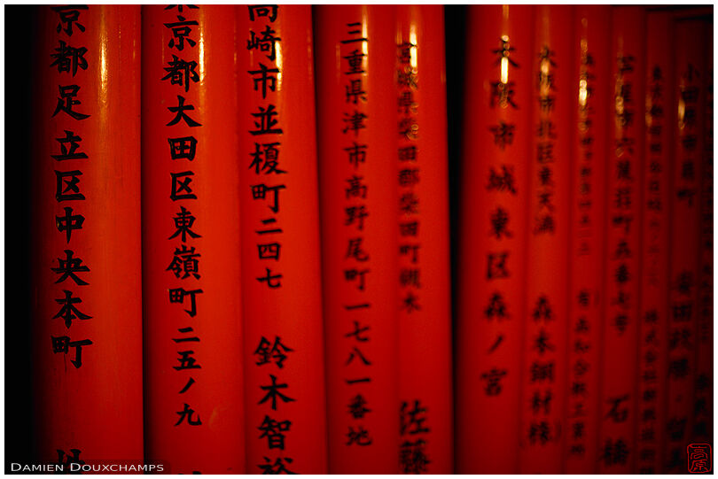 Pillars of red torii with black writings