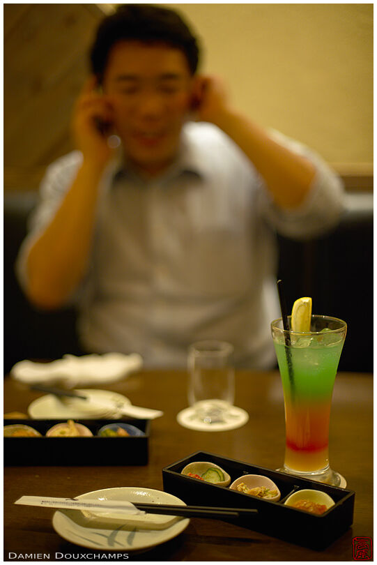 A quick last phone call before dinner in a Japanese restaurant, Tokyo, Japan