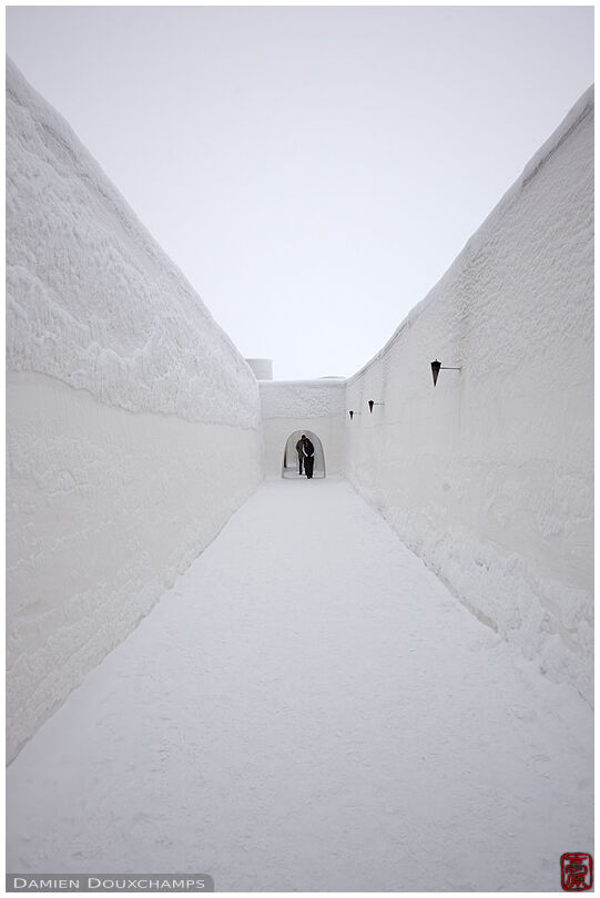 Alley between tall snow walls in the Kemi castle, Finland