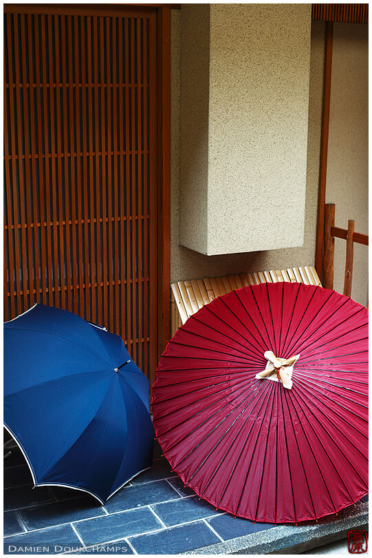 Traditional and modern umbrellas in front of a geisha house in Gion