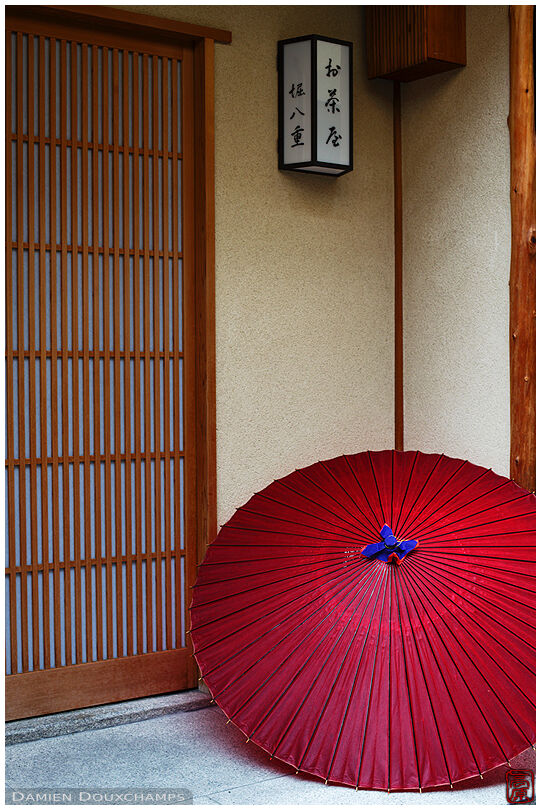Traditional umbrella in front of a exclusive house where geisha perform, Gion