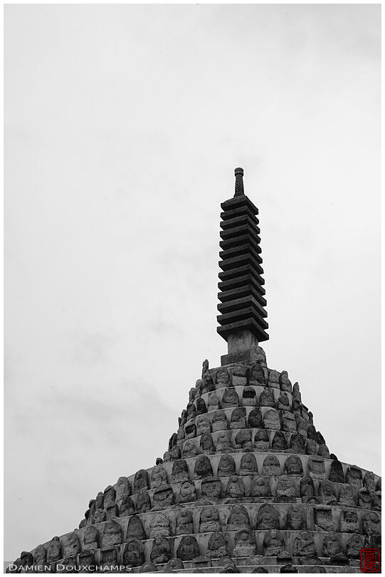 Stone pagoda atop a mountain of jizo statues, Mibu-dera temple, Kyoto, Japan