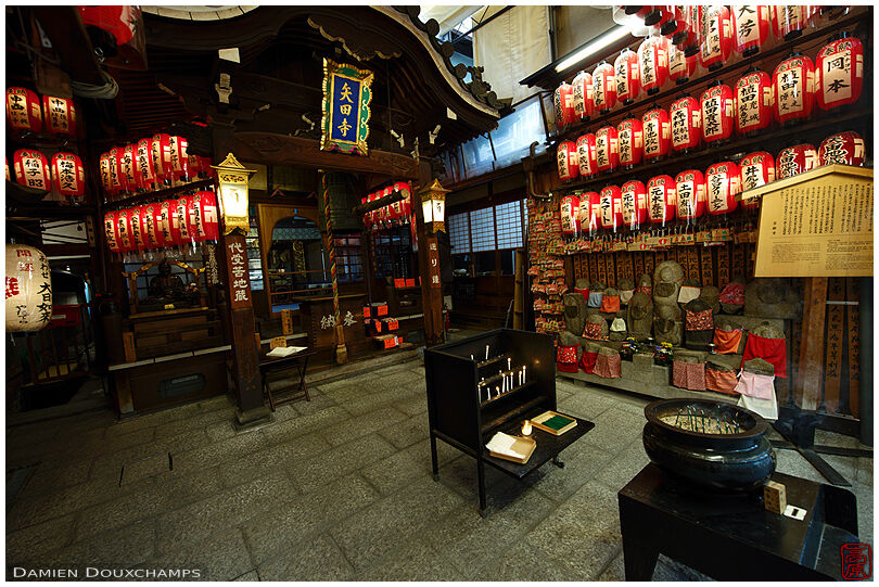 The small local temple of Yata-dera, tucked between shops in a busy street of Kyoto, Japan