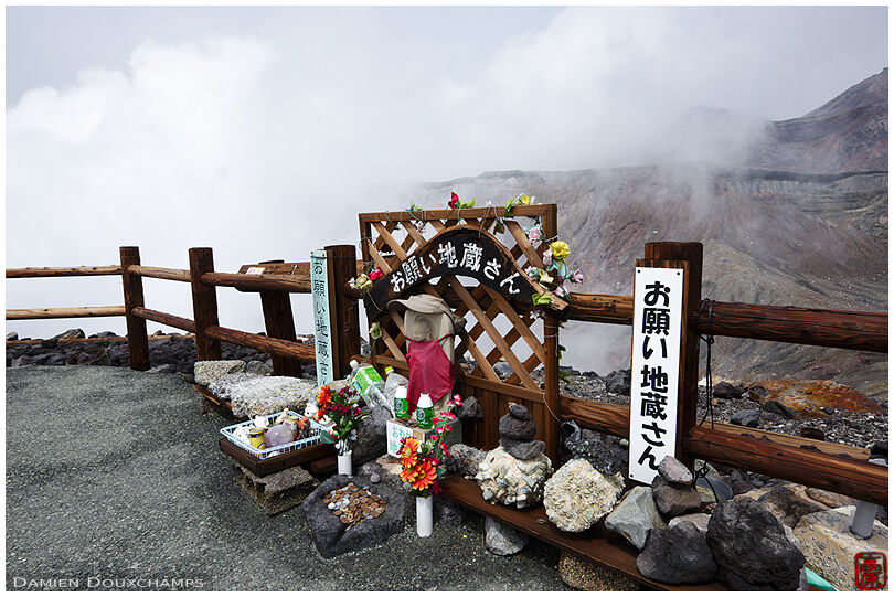 Jizo statue on the rim of Mt. Aso volcano