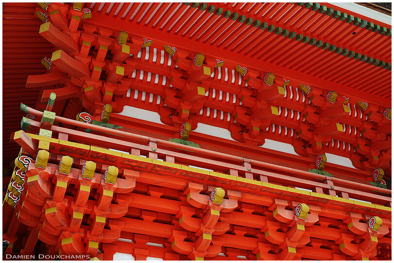 Bright red wooden structure of Usa-jingu shrine entrance gate, Oita, Japan