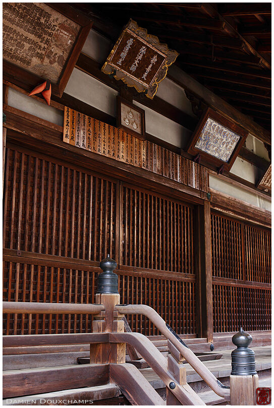 Weathered paintings and name plates hanging on Jinko-in temple main hall