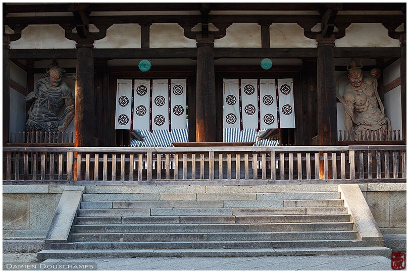 Massive gate guarded by two deity statues in one of the oldest temples in Japan: Hōryū-ji in Nara prefecture