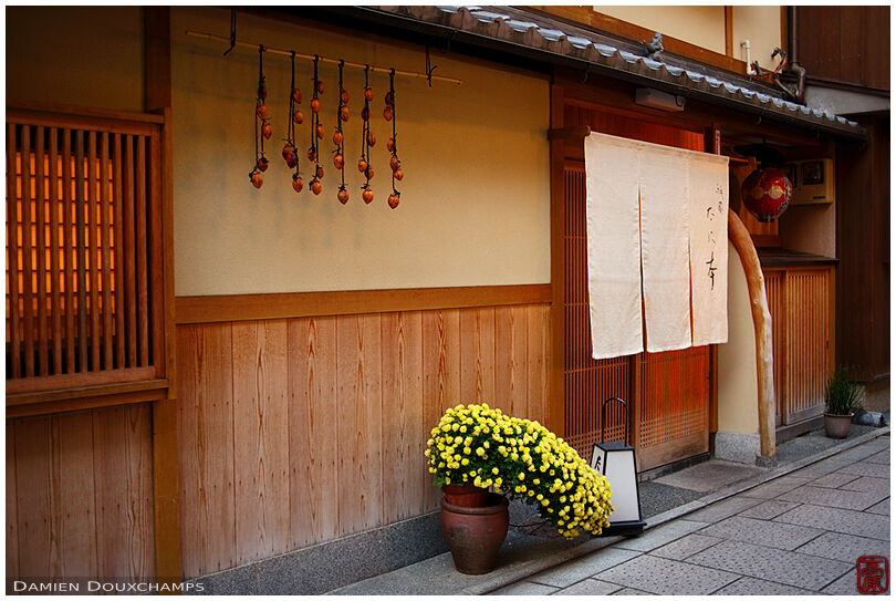 Restaurant entrance with drying persimmons in Gion