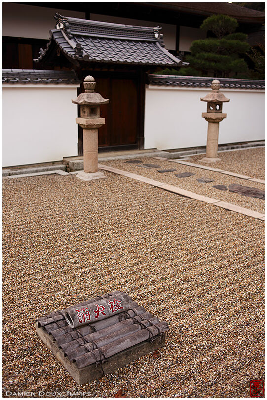 Fire hydrant or cistern indicated by painted bamboo on a raked rocked garden of Manpuku-ji temple, Kyoto, Japan