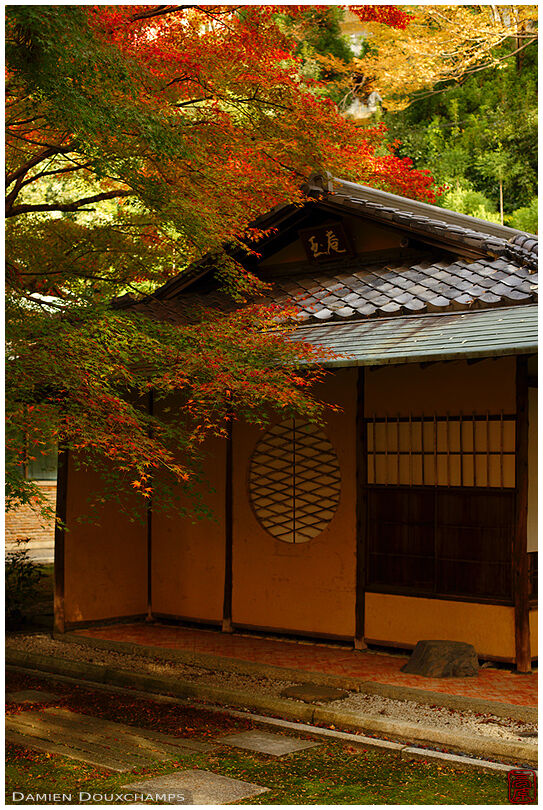 Tea house with round window in autumn, Shozan garden, Kyoto, Japan