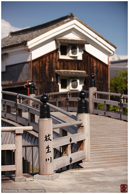 Traditional wooden bridge and kura storage house in Kyoto, Japan