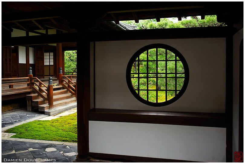 Round window at the garden entrance of Ryosoku-in temple, Kyoto, Japan