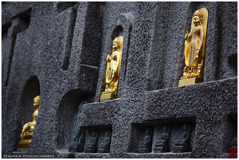 Golden Buddha statues adorning the tower of Myōman-ji temple, Kyoto, Japan