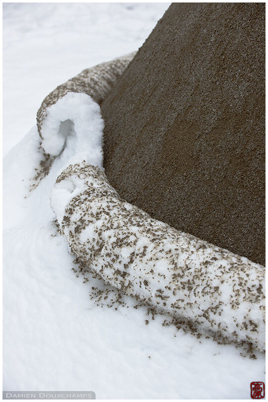 Snow carpet rolled back at the foot of a pile of sand in Ginkaku-ji temple, Kyoto, Japan
