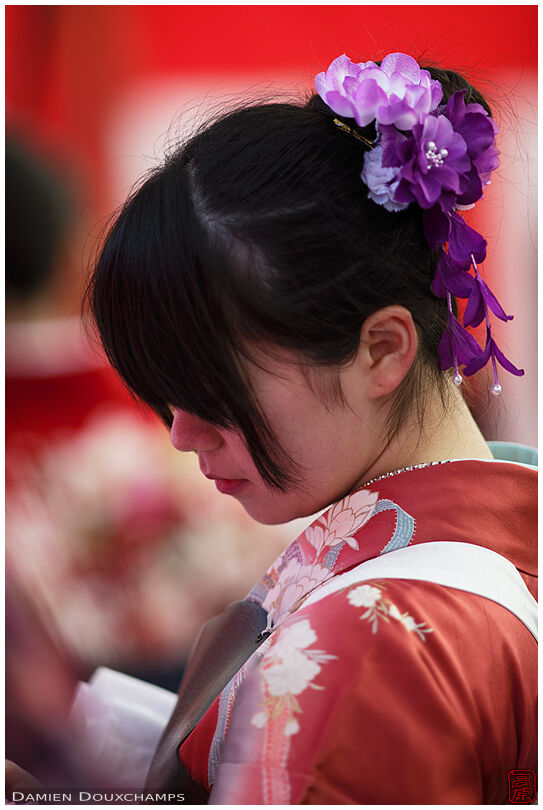 Female archer wearing red kimono during the Toshiya archery event in Sanjusangendo temple, Kyoto, Japan