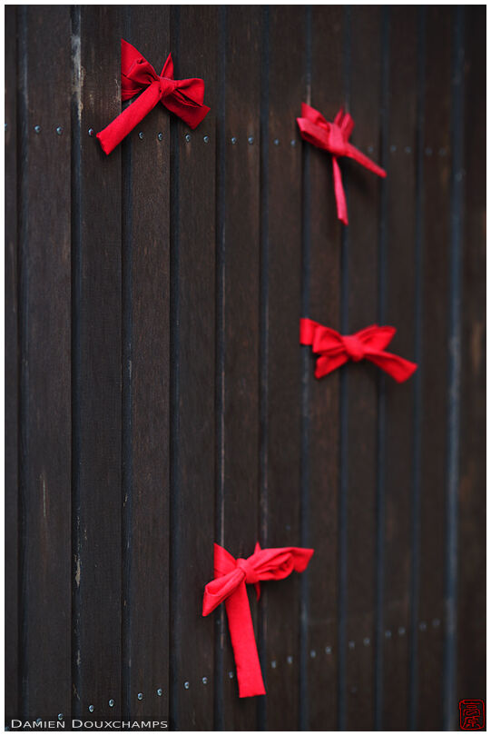 Red knots on wooden facade, Jizo-in temple, Kyoto, Japan