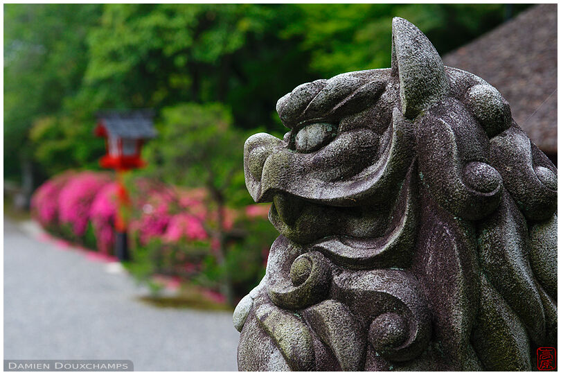 Statue guarding the gardens of Takeisao-jinja shrine during the satsuki flower season