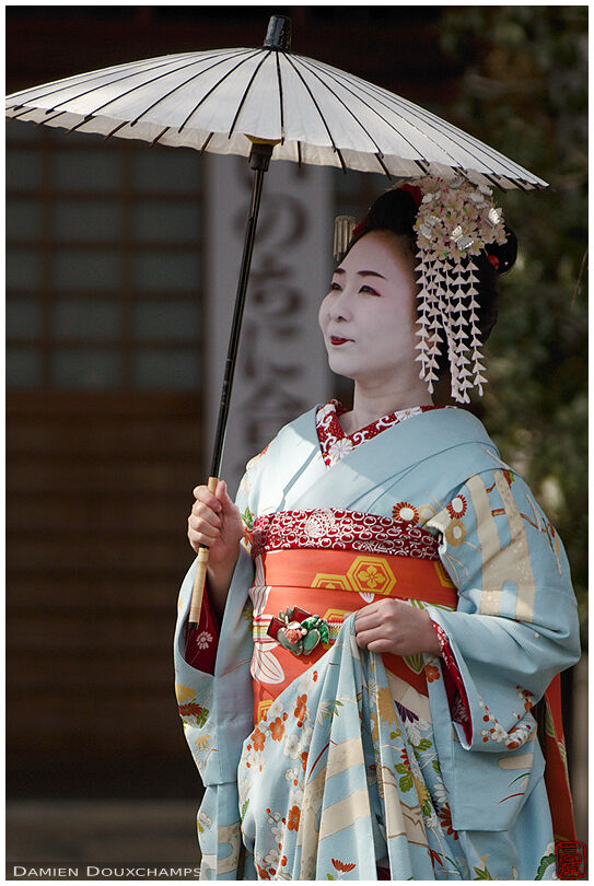 Tourist dressed as maiko with umbrella, Honman-ji temple, Kyoto, Japan
