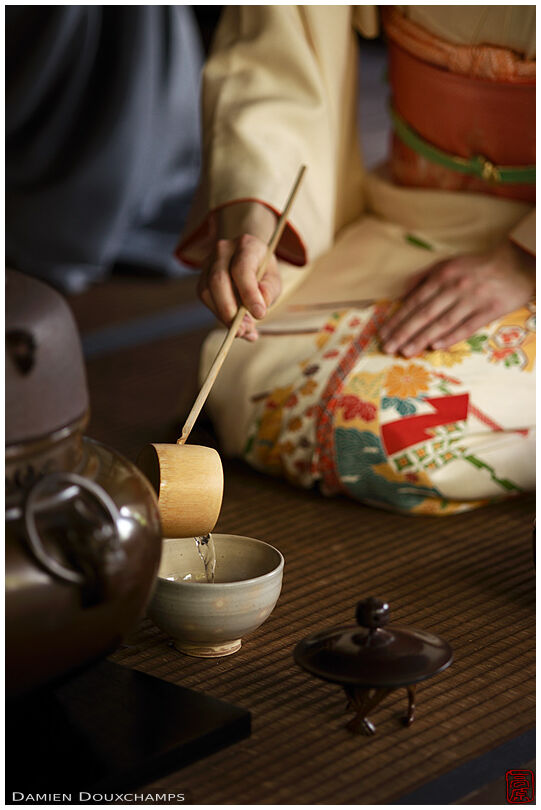 Poring water with bamboo ladle during tea ceremony in Shodensanso, Kyoto, Japan