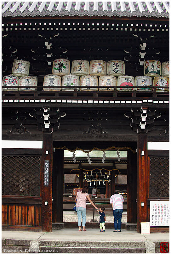 Stacked sake barrels on the entrance gate to Umenomiya shrine, Kyoto, Japan