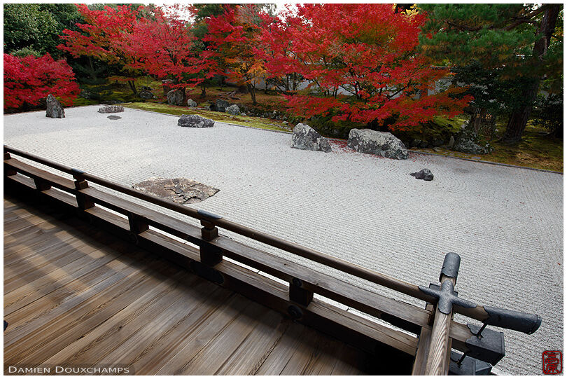 Temple terrace with view on wide rock garden surrounded by red maple foliage, Shokoku-ji temple, Kyoto, Japan