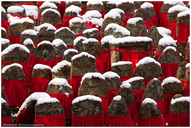 Snow-capped jizo statues with red bibs, Risho-in temple, Kyoto, Japan