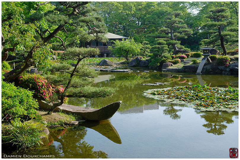 Boat-shaped stone on the pond of Keitaku-en garden, Kyoto, Japan