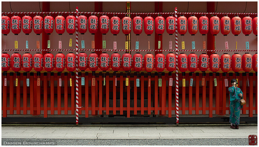 Woman taking pictures during the lantern festival of Fushimi Inari shrine, Kyoto, Japan