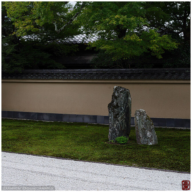 Two standing stones over the moss and rock garden of Obai-in temple, Kyoto, Japan