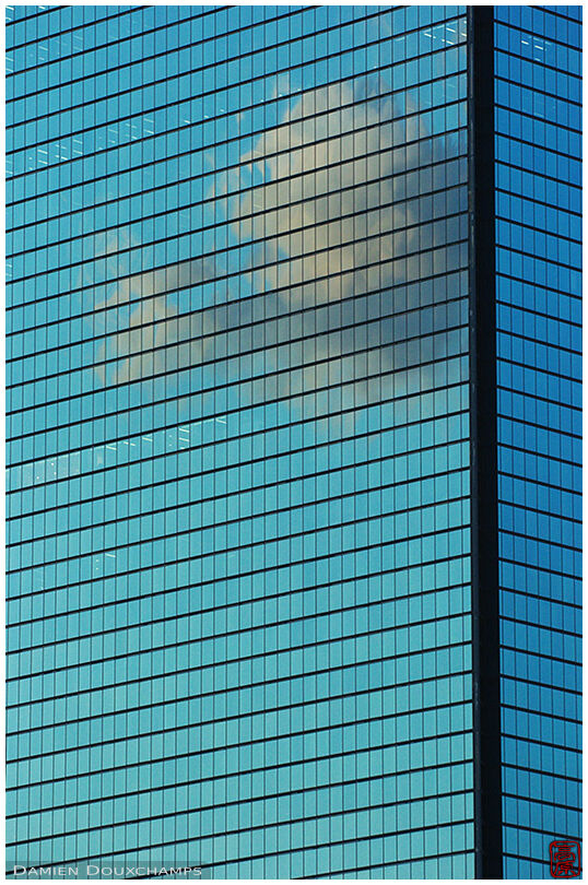 Cloud refleting on skyscraper