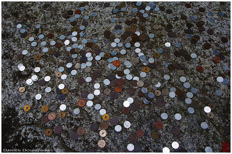 Coins on sacred stone