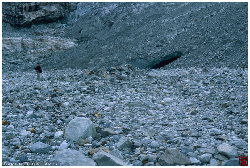Hiker among stones, Glacier du Mont Mine