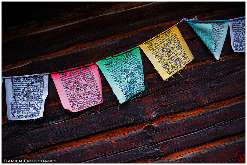 Buddhic prayers on the wall of an old chalet