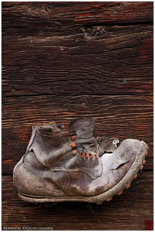 Old mountaineering shoe nailed to the wall of a chalet