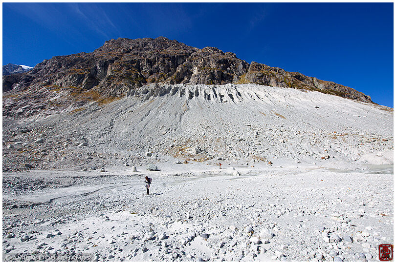 Hiker in the moraines of Ferpecle's glacier