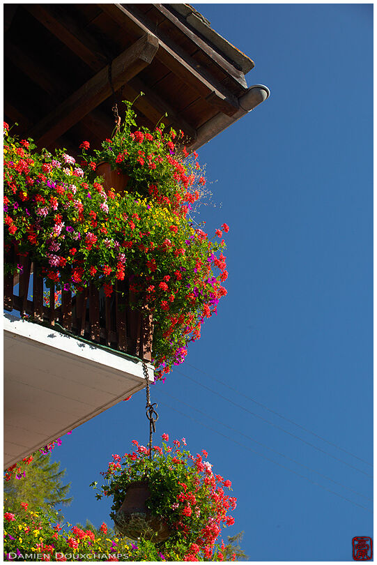 A chalet's balcony rich with flowers