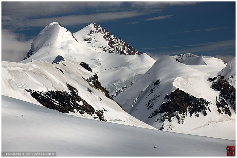 Skiers under the Castor and Pollux peaks