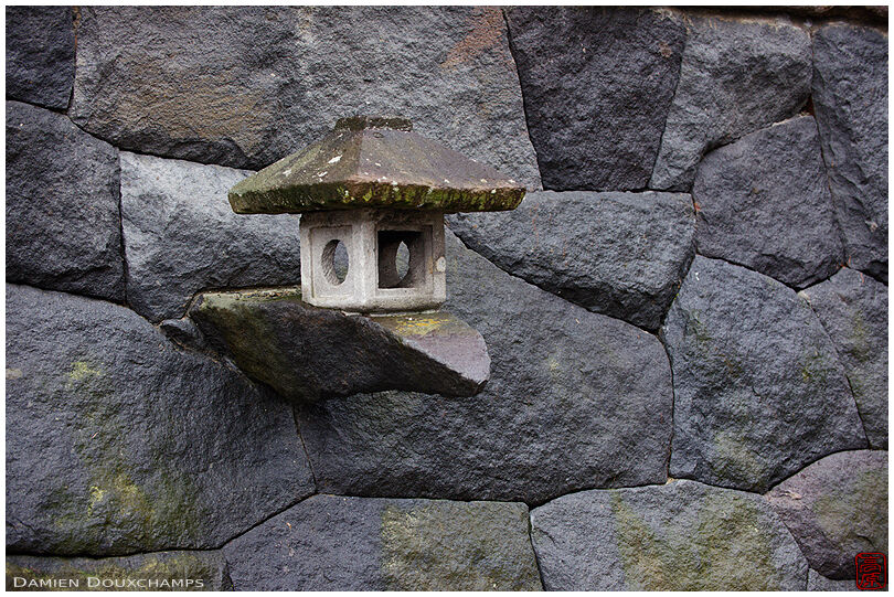 Lantern protruding from a stone wall