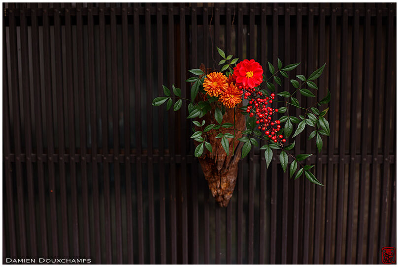 Flowers hanged to the facade of a traditional Japanese house