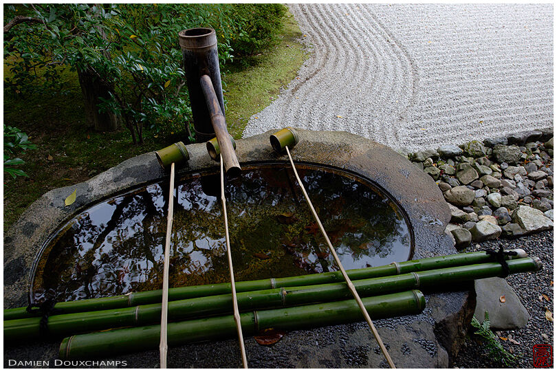 Bamboo fountain and stone wash basin in a zen garden