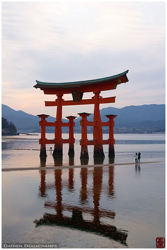 A couple of tourists admiring the torii