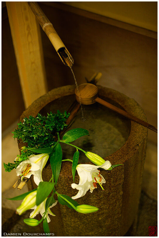 Bamboo fountain, stone wash basin and flowers