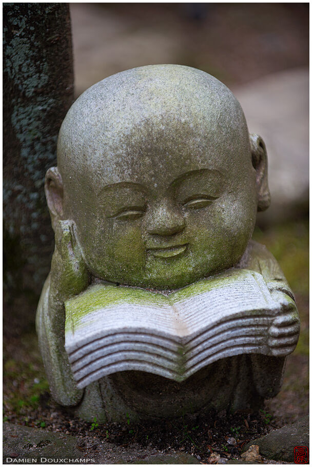 Miniature statue of a reading buddha