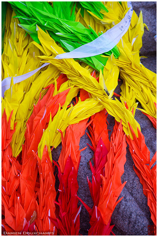 Folded cranes at the foot of the monument for Koreans victims