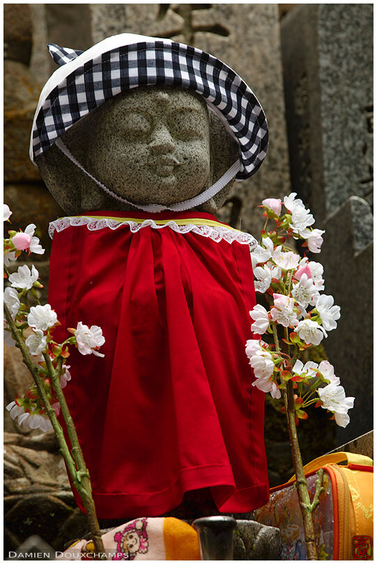 Infant tombstone with schoolgirl hat and lunch pack (Okuno-in cemetery)