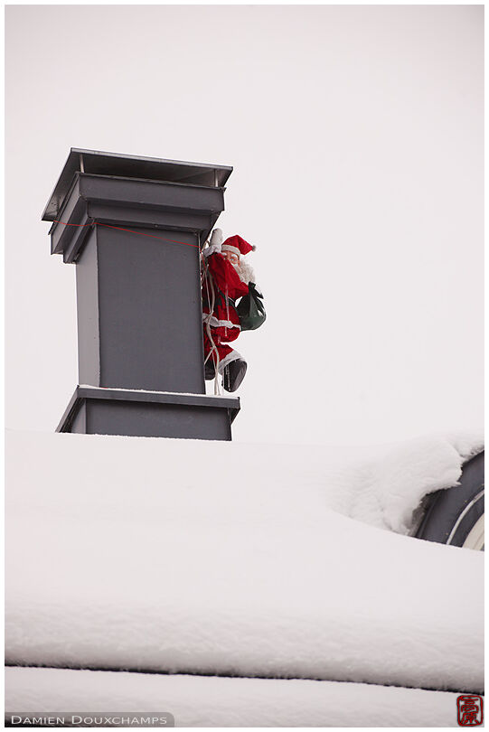 Santa Claus doll climbing a chimney
