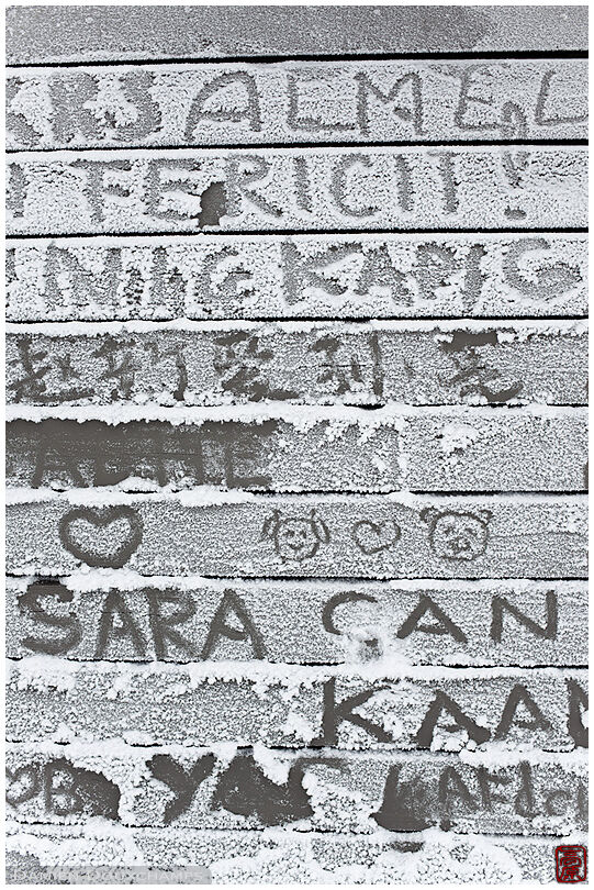 Personal messages on frost-covered wall