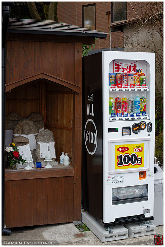 Vending machine next to a small shrine with jizo statues, Gion