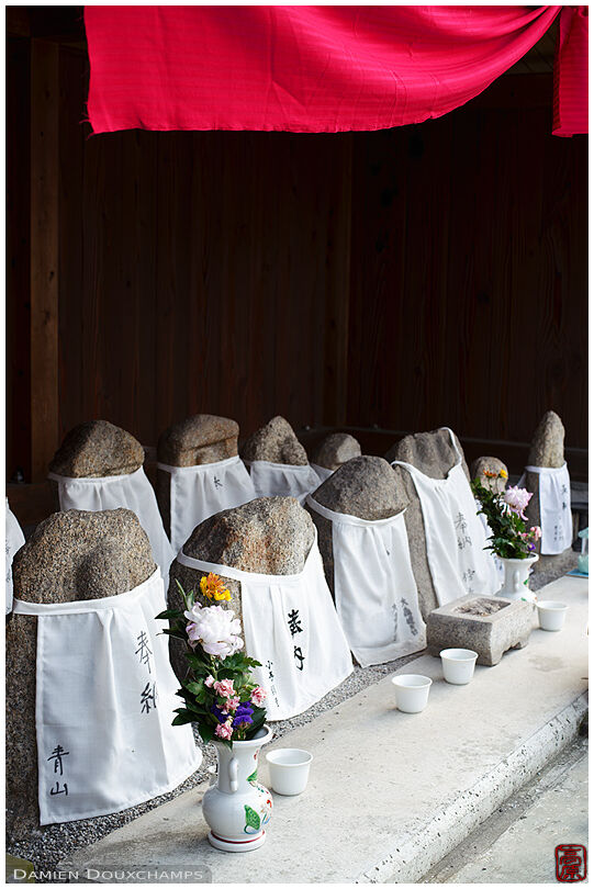 Weathered jizo statues in road-side temple